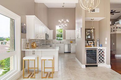 Eat-in kitchen - mid-sized contemporary galley eat-in kitchen idea in San Diego with shaker cabinets, white cabinets, quartz countertops, multicolored backsplash, porcelain backsplash, no island, white countertops and an undermount sink