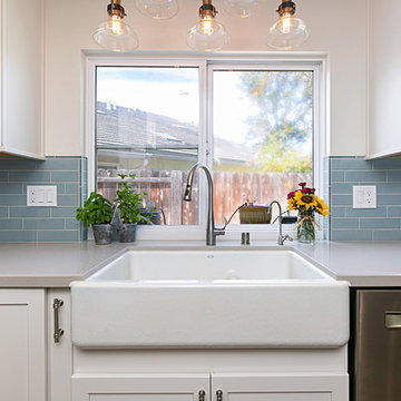 Farmhouse Kitchen Sink Surrounded by White Cabinets