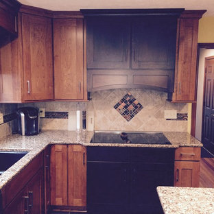 Mid-sized arts and crafts u-shaped eat-in kitchen in Indianapolis with an undermount sink, recessed-panel cabinets, medium wood cabinets, quartz benchtops, metallic splashback, ceramic splashback, stainless steel appliances, ceramic floors and with island.