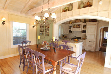 Country u-shaped eat-in kitchen photo in San Francisco with white cabinets