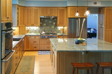 Inspiration for a contemporary l-shaped light wood floor enclosed kitchen remodel in San Diego with flat-panel cabinets, light wood cabinets, soapstone countertops, cement tile backsplash, stainless steel appliances and an island