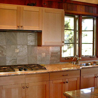 Design ideas for a mid-sized arts and crafts galley eat-in kitchen in San Francisco with shaker cabinets, medium wood cabinets, granite benchtops, slate splashback, with island, an undermount sink, stainless steel appliances, brown floor, multi-coloured splashback and medium hardwood floors.