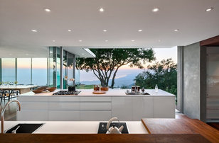 Example of a minimalist open concept kitchen design in Santa Barbara with a drop-in sink, flat-panel cabinets and white cabinets