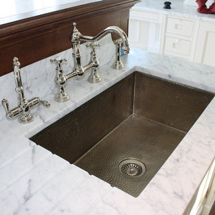 Eat-in kitchen - large traditional l-shaped dark wood floor eat-in kitchen idea in New York with an undermount sink, glass-front cabinets, white cabinets, white backsplash, stone slab backsplash, stainless steel appliances and an island