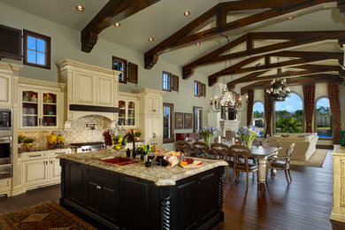 Large tuscan l-shaped dark wood floor and brown floor open concept kitchen photo in Orlando with an undermount sink, raised-panel cabinets, white cabinets, granite countertops, multicolored backsplash, paneled appliances, two islands and mosaic tile backsplash