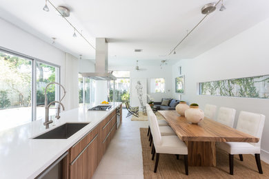 Example of a mid-sized trendy ceramic tile eat-in kitchen design in Miami with an undermount sink, flat-panel cabinets, medium tone wood cabinets, quartz countertops, stainless steel appliances, an island, blue backsplash and glass tile backsplash