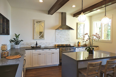 Example of a transitional u-shaped eat-in kitchen design in San Francisco with shaker cabinets, white cabinets, an undermount sink, quartz countertops, multicolored backsplash, stone tile backsplash and stainless steel appliances