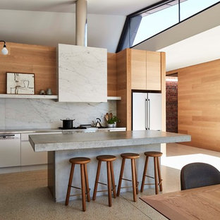 This is an example of a contemporary single-wall eat-in kitchen in Melbourne with flat-panel cabinets, white cabinets, grey splashback, white appliances, with island and grey benchtop.