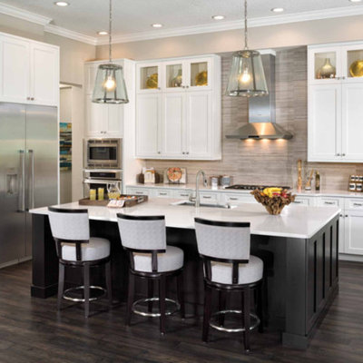 Inspiration for a large transitional l-shaped dark wood floor and brown floor eat-in kitchen remodel in San Diego with an undermount sink, shaker cabinets, stainless steel appliances, an island, solid surface countertops, beige backsplash and stone tile backsplash