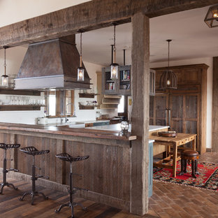 Large farmhouse eat-in kitchen ideas - Inspiration for a large country u-shaped eat-in kitchen remodel in Denver with a farmhouse sink, shaker cabinets, distressed cabinets, white backsplash, ceramic backsplash and an island