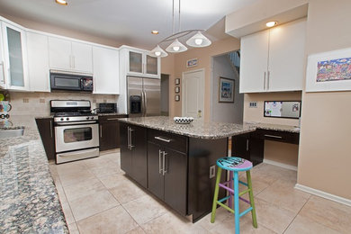 Example of a mid-sized eclectic l-shaped eat-in kitchen design in Philadelphia with an undermount sink, shaker cabinets, dark wood cabinets, granite countertops, beige backsplash, stainless steel appliances and an island