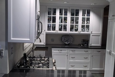Inspiration for a medium sized traditional galley kitchen/diner in Philadelphia with granite worktops, slate flooring, a submerged sink, shaker cabinets, white cabinets, stainless steel appliances, a breakfast bar and grey floors.
