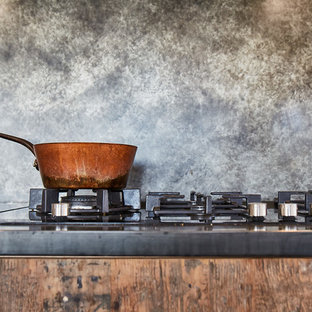 Inspiration for a large industrial open plan kitchen in Other with an undermount sink, flat-panel cabinets, medium wood cabinets, zinc benchtops, grey splashback, stainless steel appliances, concrete floors, a peninsula, grey floor and grey benchtop.