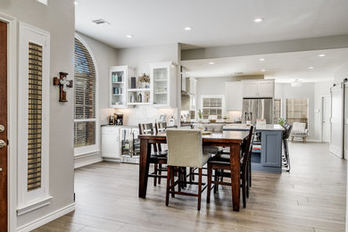 Mid-sized cottage l-shaped porcelain tile, gray floor and vaulted ceiling eat-in kitchen photo in Austin with an undermount sink, flat-panel cabinets, gray cabinets, quartz countertops, blue backsplash, cement tile backsplash, stainless steel appliances, an island and white countertops
