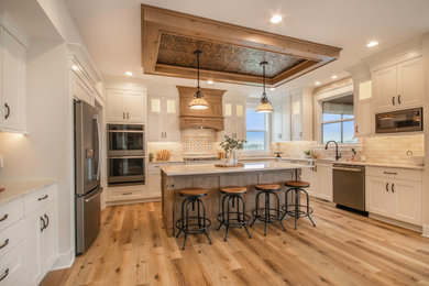 Inspiration for a transitional u-shaped vinyl floor open concept kitchen remodel in Grand Rapids with shaker cabinets, white cabinets, wood countertops, stone tile backsplash, stainless steel appliances, an island and white countertops