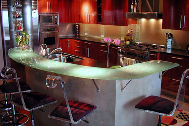 Trendy kitchen photo in Seattle with glass countertops, glass sheet backsplash and green countertops