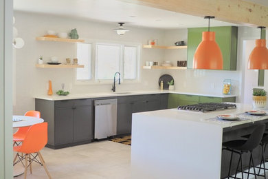 1960s u-shaped beige floor eat-in kitchen photo in Other with an undermount sink, flat-panel cabinets, green cabinets, white backsplash, subway tile backsplash, stainless steel appliances, an island and white countertops