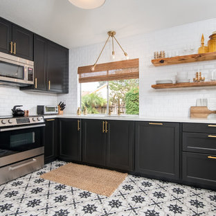 Inspiration for a mid-sized contemporary l-shaped separate kitchen in Los Angeles with an undermount sink, shaker cabinets, black cabinets, quartz benchtops, white splashback, subway tile splashback, stainless steel appliances, porcelain floors, no island and white floor.