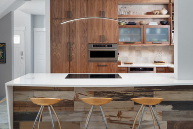 Inspiration for a mid-sized modern u-shaped medium tone wood floor open concept kitchen remodel in Other with an undermount sink, flat-panel cabinets, medium tone wood cabinets, quartz countertops, gray backsplash, ceramic backsplash, stainless steel appliances, a peninsula and white countertops