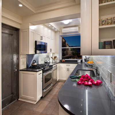 Kitchen - small contemporary galley kitchen idea in New York with a drop-in sink, white cabinets, white backsplash, ceramic backsplash and stainless steel appliances