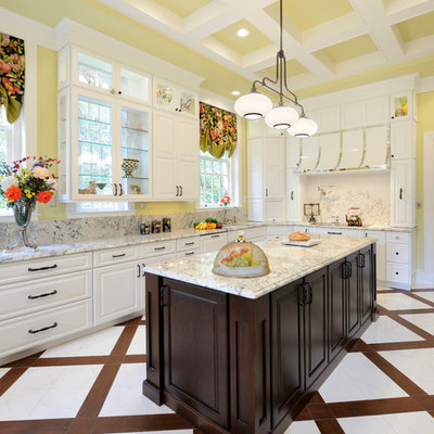 Example of a huge transitional u-shaped porcelain tile enclosed kitchen design in St Louis with white cabinets, granite countertops, an island, raised-panel cabinets, stone slab backsplash and paneled appliances