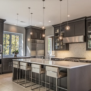 Mid-sized transitional kitchen inspiration - Mid-sized transitional l-shaped porcelain tile kitchen photo in Other with a farmhouse sink, shaker cabinets, white backsplash, stainless steel appliances, an island, stone tile backsplash and black cabinets