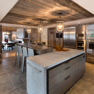 Inspiration for a rustic l-shaped kitchen with flat-panel cabinets, medium wood cabinets, stainless steel appliances, an island, grey floors, grey worktops and a wood ceiling.