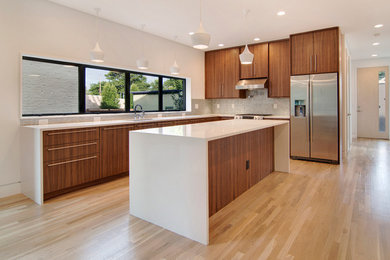 Eat-in kitchen - large contemporary l-shaped light wood floor eat-in kitchen idea in Denver with an undermount sink, flat-panel cabinets, dark wood cabinets, quartz countertops, metallic backsplash, metal backsplash, stainless steel appliances and an island