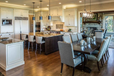 Eat-in kitchen - large transitional l-shaped dark wood floor and brown floor eat-in kitchen idea with a drop-in sink, beaded inset cabinets, white cabinets, granite countertops, beige backsplash, glass tile backsplash, stainless steel appliances, an island and beige countertops