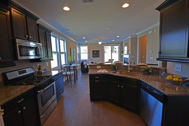 Transitional dark wood floor eat-in kitchen photo in Charleston with dark wood cabinets, granite countertops and stainless steel appliances