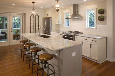 Large danish medium tone wood floor and brown floor eat-in kitchen photo in Atlanta with an undermount sink, shaker cabinets, gray cabinets, granite countertops, white backsplash, cement tile backsplash, stainless steel appliances and an island