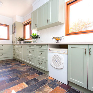 This is an example of a small country galley kitchen in Other with a double-bowl sink, shaker cabinets, green cabinets, solid surface benchtops, white splashback, metal splashback, slate floors, multi-coloured floor and beige benchtop.