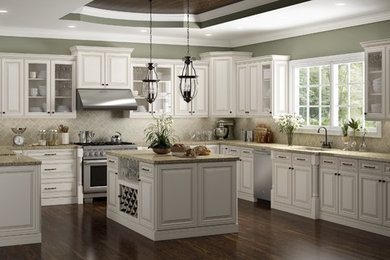 Eat-in kitchen - huge contemporary u-shaped laminate floor and brown floor eat-in kitchen idea with an undermount sink, raised-panel cabinets, light wood cabinets, granite countertops, beige backsplash, porcelain backsplash, stainless steel appliances, an island and beige countertops