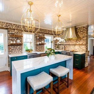 Inspiration for a mid-sized transitional kitchen pantry in Charleston with a farmhouse sink, beaded inset cabinets, green cabinets, quartz benchtops, brown splashback, brick splashback, stainless steel appliances, medium hardwood floors, with island, brown floor and white benchtop.
