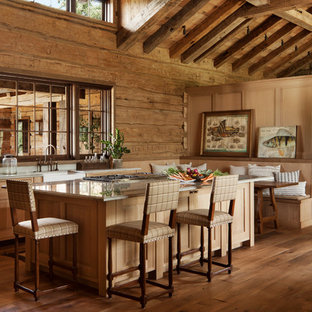 Rustic kitchen pictures - Example of a mountain style medium tone wood floor kitchen design in Other with a farmhouse sink, shaker cabinets, medium tone wood cabinets, wood backsplash and an island
