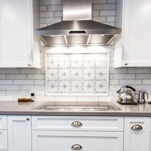 Ispirazione per un'ampia cucina minimalista con lavello stile country, ante in stile shaker, ante bianche, top in granito, paraspruzzi bianco, paraspruzzi con piastrelle diamantate, elettrodomestici in acciaio inossidabile, pavimento con piastrelle in ceramica e isola