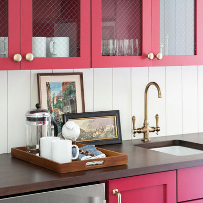 Example of a small beach style galley vinyl floor and brown floor kitchen design in Milwaukee with an undermount sink, glass-front cabinets, red cabinets, wood countertops, white backsplash, wood backsplash, stainless steel appliances and brown countertops