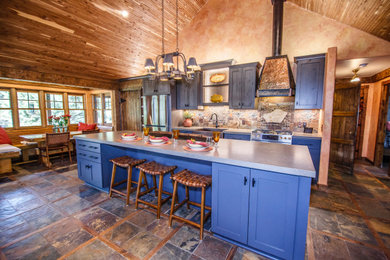 Eat-in kitchen - mid-sized rustic eat-in kitchen idea in Other with a farmhouse sink, shaker cabinets, quartz countertops, stainless steel appliances and an island