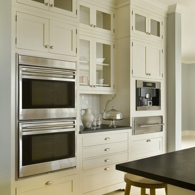 Example of a trendy kitchen design in Providence with shaker cabinets, stainless steel appliances, subway tile backsplash, white cabinets and white backsplash