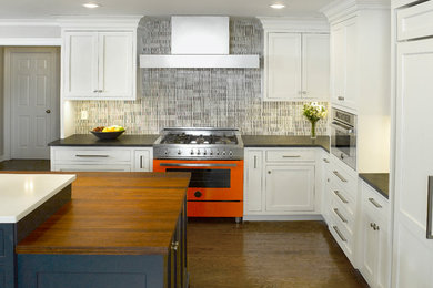 Kitchen - transitional kitchen idea in New York with white cabinets, ceramic backsplash and an island