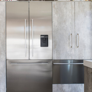 Large contemporary open concept kitchen pictures - Example of a large trendy l-shaped light wood floor open concept kitchen design in Los Angeles with an undermount sink, flat-panel cabinets, beige backsplash, stone tile backsplash, stainless steel appliances, an island, distressed cabinets and solid surface countertops