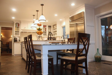 Inspiration for a large transitional u-shaped eat-in kitchen remodel in Other with shaker cabinets, white cabinets, white backsplash, stainless steel appliances and an island
