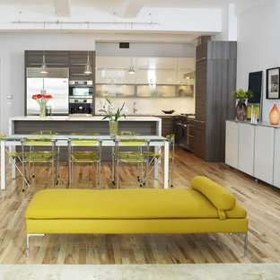 Example of a trendy l-shaped eat-in kitchen design in New York with flat-panel cabinets, stainless steel appliances, gray cabinets and marble countertops