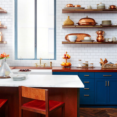Mid-sized eclectic l-shaped dark wood floor open concept kitchen photo in San Francisco with a farmhouse sink, shaker cabinets, blue cabinets, wood countertops, white backsplash, subway tile backsplash and an island