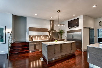 Example of a mid-sized trendy galley dark wood floor eat-in kitchen design in Atlanta with a double-bowl sink, flat-panel cabinets, medium tone wood cabinets, quartz countertops, metallic backsplash, metal backsplash, stainless steel appliances and an island