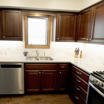 Cherry Cabinets with Beige Countertops and Calacutta Marble Backsplash