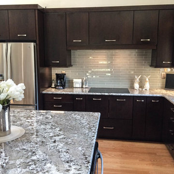 Cherry cabinets with slab doors, a custom-mixed stain, Bianco Antico granite and