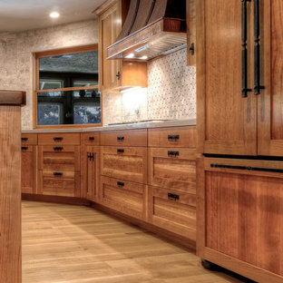 Design ideas for a mid-sized arts and crafts u-shaped open plan kitchen in Other with a farmhouse sink, shaker cabinets, medium wood cabinets, wood benchtops, white splashback, stone tile splashback, coloured appliances, light hardwood floors and with island.