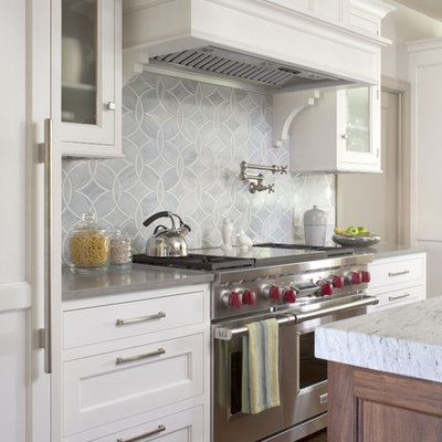 Inspiration for a transitional kitchen remodel in Denver with stainless steel appliances, recessed-panel cabinets, white cabinets, blue backsplash and quartz countertops