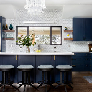Transitional kitchen designs - Transitional l-shaped dark wood floor and brown floor kitchen photo in Denver with shaker cabinets, blue cabinets, white backsplash, stainless steel appliances, an island and white countertops